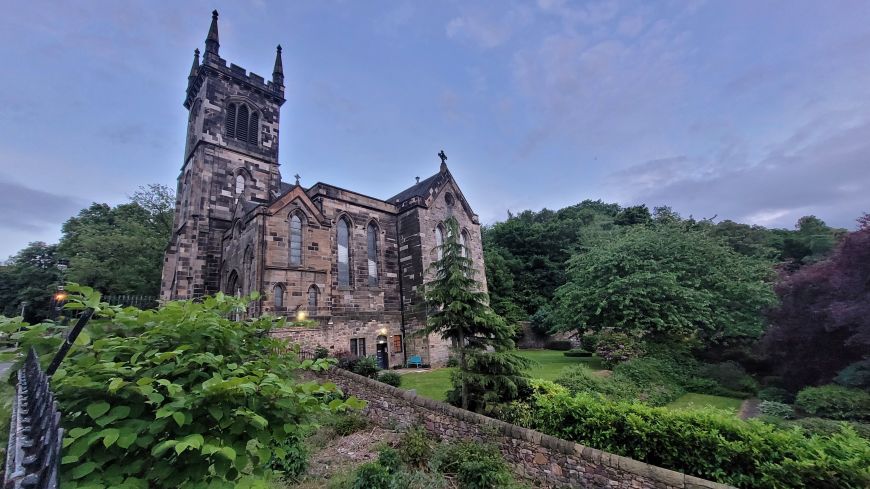 Greenside Parish Church surrounded by trees and gardens