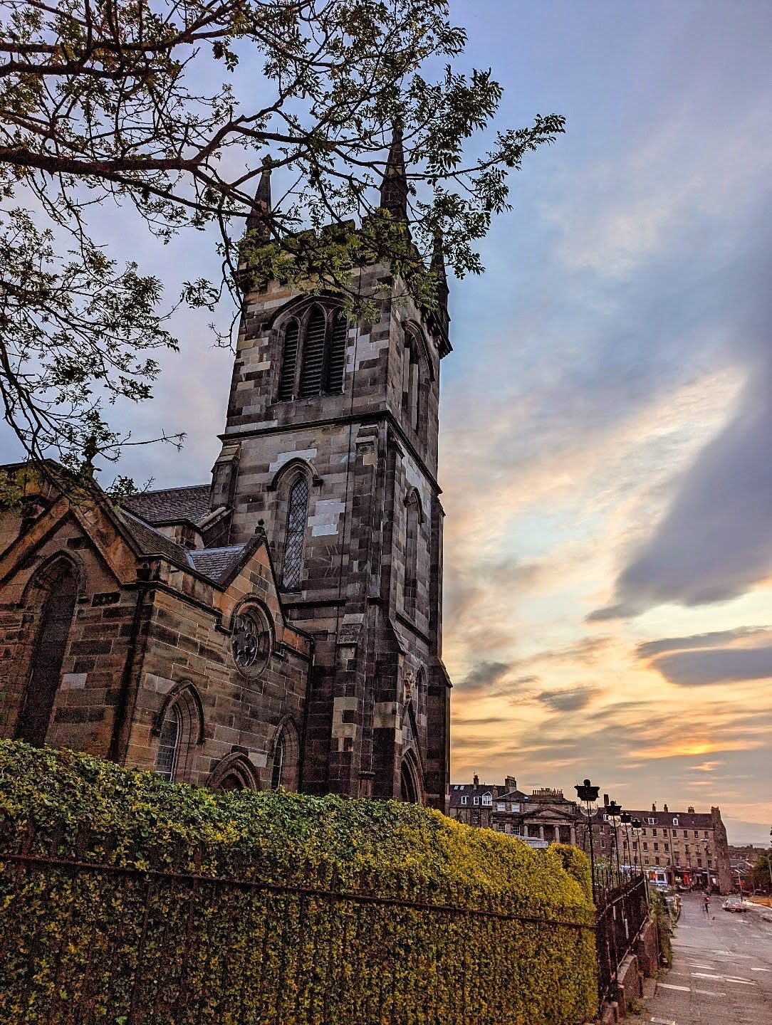 Greenside Parish Church at sunset, showing the Gothic Revival tower against an Edinburgh sky